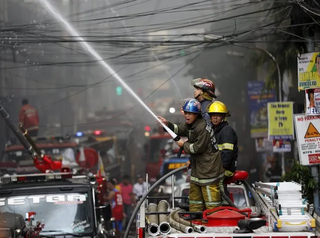 Members of the Filipino fire services try to exstinguish a fire at the University of the East in Manila, Philippines, 02 April 2016. A blaze struck the Manila campus of the University of the East (UE), wherein a day earlier at the state owned, University of the Philippines was similarly hit by fire, according to fire officials. Students, faculty and staff members have been evacuated when the fire broke out. There were no immediate reports of casualties. (Photo by Francis R. Malasig/EPA)