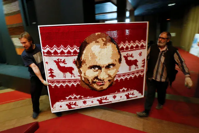 Workers carry a portrait of Russian President Vladimir Putin, knitted with huge wooden needles by artist Natalia Yudina, during preparations for the Museum Night at Krasnoyarsk Museum Centre in the Siberian city of Krasnoyarsk, Russia, April 13, 2016. (Photo by Ilya Naymushin/Reuters)