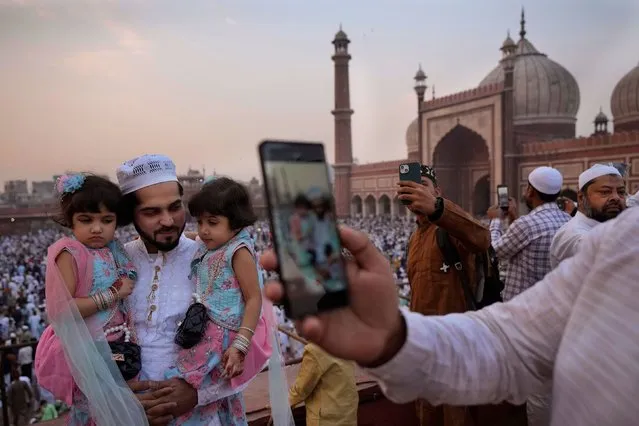 Devout Muslims gather with their families take selfies after offering Eid al-Fitr prayer, marking the end of the fasting month of Ramadan at Jama Masjid, in New Delhi, India, Thursday, April 11, 2024. (Photo by Manish Swarup/AP Photo)