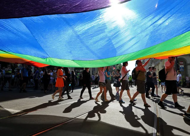 Marchers carry a multicolor flag during the annual gay pride parade in Warsaw, Poland, Saturday, June 13, 2015. Gay rights activists held their 15th yearly "Equality Parade" as Poland slowly grows more accepting of gays and lesbians, but where gay marriage, and even legal partnerships, still appear to be a far-off dream. This year's parade comes amid a right-wing political shift, a possible setback for the LGBT community. (AP Photo/Alik Keplicz)