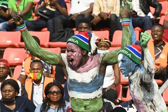 Gambia supporters cheer during the Africa Cup of Nations (CAN) 2021 round of 16 football match between Guinea and Gambia at Stade de Kouekong in Bafoussam on January 24, 2022. (Photo by Pius Utomi Ekpei/AFP Photo)