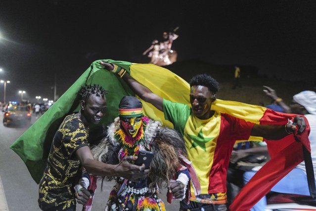 Senegal fans in Dakar celebrate their team's victory against Egypt in the African Cup of Nations soccer final played in Yaounde, Cameroon on Sunday, February 6, 2022. (Photo by Sylvain Cherkaoui/AP Photo)