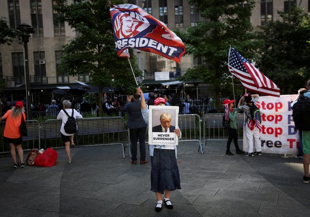 A supporter of former U.S. President Donald Trump waves a flag outside the Manhattan criminal court during jury deliberations in his criminal trial over charges that he falsified business records to conceal money paid to silence p*rn star Stormy Daniels in 2016, in New York City, U.S. May 29, 2024. (Photo by Mike Segar/Reuters)