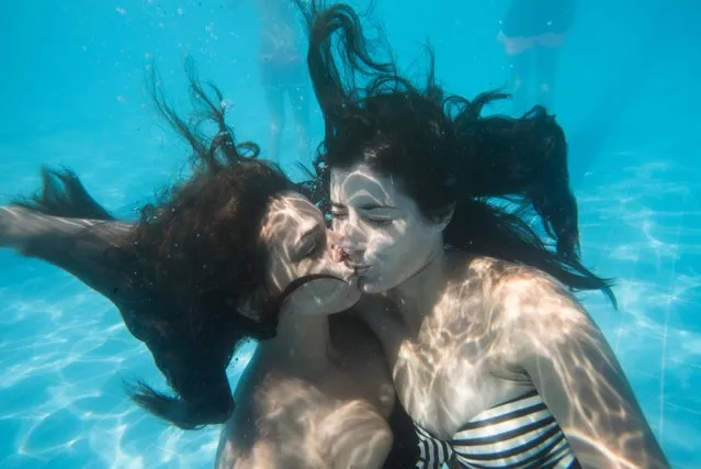 Close-up of young women kissing in swimming pool. (Photo by Teresa Recena/EyeEm/Getty Images)