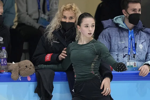 Coach Eteri Tutberidze, left, talks to Kamila Valieva, center, of the Russian Olympic Committee, during a training session at the 2022 Winter Olympics, Sunday, February 13, 2022, in Beijing. (Photo by David J. Phillip/AP Photo)