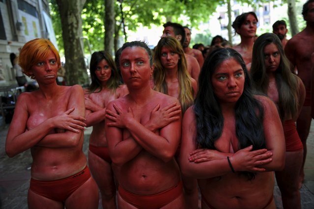 Animal rights protesters wait before the start of a demonstration calling for the abolition of bull runs and bullfights, three days before the start of the famous running of the bulls San Fermin festival in Pamplona, northern Spain, July 4, 2015. (Photo by Eloy Alonso/Reuters)