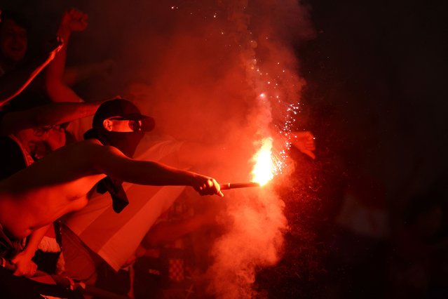 A Croatia fan with a flare in the stands before their Euro match against Italy in Leipzig, Germany on June 24, 2024. (Photo by Lisi Niesner/Reuters)