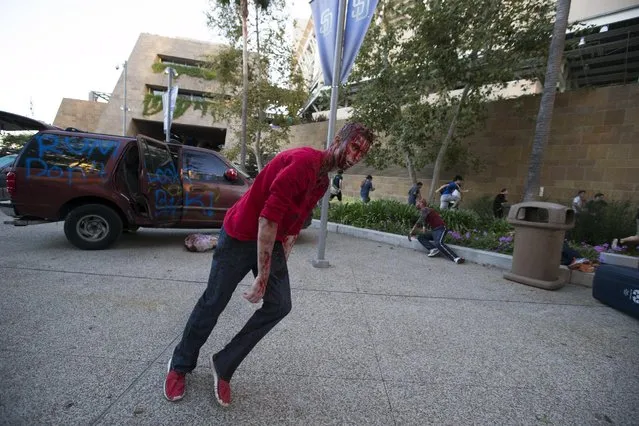 A person dressed like a zombie takes part in The Walking Dead Escape experience at Petco Park during the 2015 Comic-Con International Convention in San Diego, California July 10, 2015. (Photo by Mario Anzuoni/Reuters)