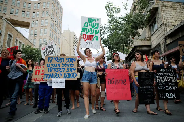 Women hold placards during a “SlutWalk” protest, during which several hundred participants march through the centre of Jerusalem, May 13, 2016. The SlutWalk movement began after a Toronto policeman suggested in 2011 that women could avoid sexual assault by not dressing like a “sl*t”. (Photo by Amir Cohen/Reuters)
