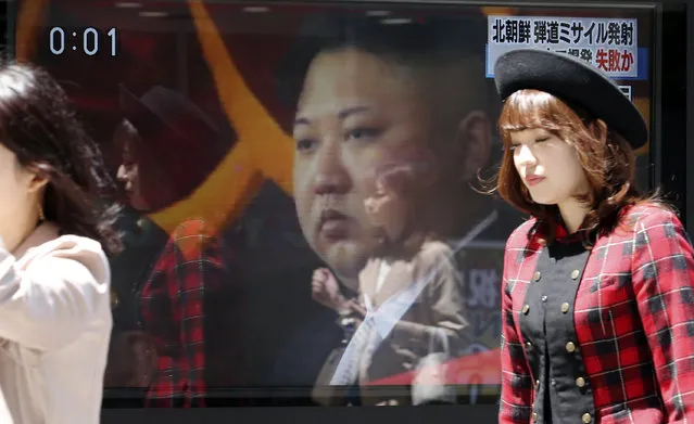 People walk past a TV news showing an image of North Korean leader Kim Jong Un while reporting North Korea's missile test, in Tokyo, Saturday, April 29, 2017. A North Korean mid-range ballistic missile apparently failed shortly after launch Saturday, South Korea and the United States said, the third test-fire flop just this month but a clear message of defiance as a U.S. supercarrier conducts drills in nearby waters. (Photo by Koji Sasahara/AP Photo)