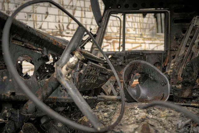 A pierced helmet sits inside a cabin of a Russian military truck, destroyed during fighting between Russian and Ukrainian forces, outside of Kyiv, Ukraine, Friday, April 1, 2022. Emergency relief and evacuation convoys for the besieged Ukrainian city of Mariupol remained in doubt Friday following reports of Russian interference, while Russian officials accused Ukraine of flying helicopter gunships across a border between the two countries and striking an oil depot. (Photo by Vadim Ghirda/AP Photo)