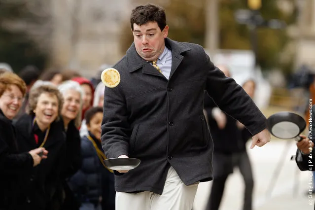A competitor looses control of his pancake while racing during the Shrove Tuesday, or Mardi Gras, tradition at the National Cathedral
