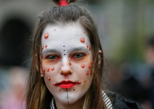 A participant takes part in a “Zombie Walk” parade to celebrate upcoming Halloween in Kiev, Ukraine on October 26, 2019. (Photo by Gleb Garanich/Reuters)