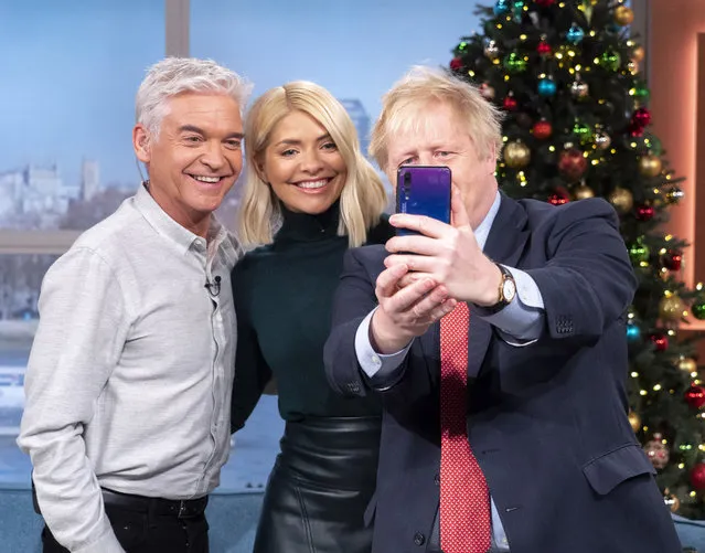 Phillip Schofield and Holly Willoughby pose for a selfie with Boris Johnson on the set of This Morning in London, England on December 5, 2019. (Photo by Ken McKay/ITV/Rex Features/Shutterstock)