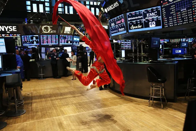 A dancer for the Hong Kong Economic and Trade Office, which rang the Opening Bell, is viewed on the floor of the New York Stock Exchange (NYSE) on July 27, 2015 in New York City. The Dow Jones industrial average was down 150 points in morning trading following a steep overnight decline in the volatile Chinese exchange. (Photo by Spencer Platt/Getty Images)