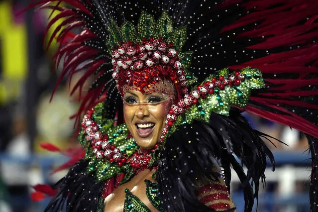 A performer from the Unidos da Tijuca samba school parades during Carnival celebrations at the Sambadrome in Rio de Janeiro, Brazil, Sunday, April 24, 2022. (Photo by Silvia Izquierdo/AP Photo)