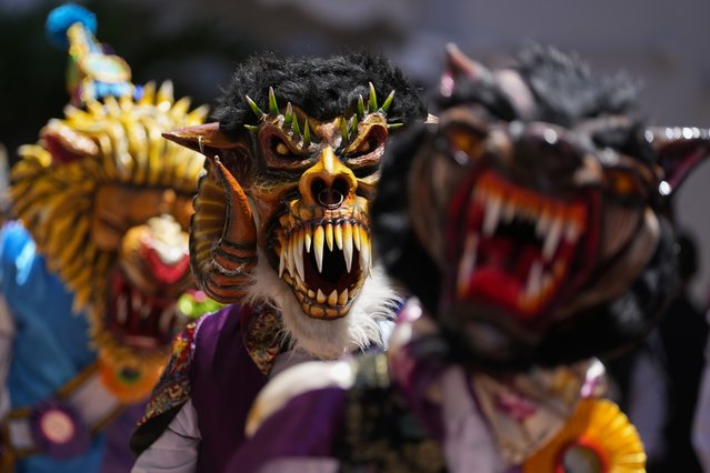 Dancers wearing devil masks perform during a Corpus Christi procession near the Santa Maria La Antigua basilica in Panama City, Sunday, June 18, 2023. Corpus Christi is a religious festival that celebrates the body and blood of Christ. (Photo by Arnulfo Franco/AP Photo)