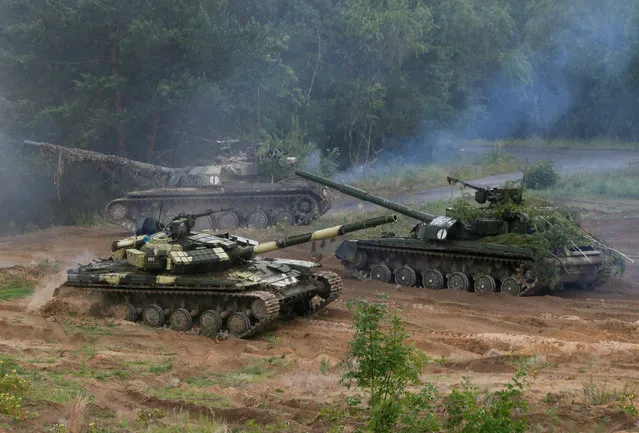 Ukrainian T-64 tanks are seen during during a military exercise for Ukrainian army reservists at a shooting range near the village of Goncharivske in Chernihiv region, Ukraine, June 22, 2016. (Photo by Valentyn Ogirenko/Reuters)