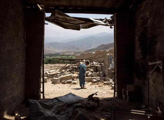 A boy walks through buildings damaged from fighting on July 15, 2017 in Shadal Bazaar, Afghanistan. People are slowly returning to the recently liberated area, which had previously been a front line of fighting against the Islamic State of Iraq and Syria – Khorasan (ISIS-K) in Achin District of Nangarhar Province. (Photo by Andrew Renneisen/Getty Images)