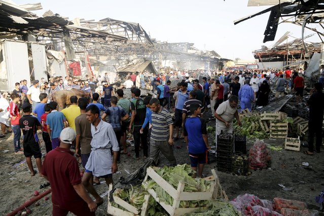 People gather at the site of a truck bomb attack at a crowded market in Baghdad August 13, 2015. (Photo by Wissm Al- Okili/Reuters)