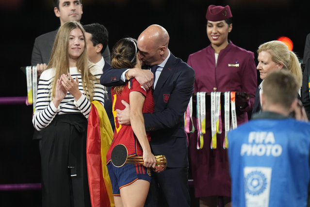 President of Spain's soccer federation, Luis Rubiales, right, hugs Spain's Aitana Bonmati on the podium following Spain's win in the final of Women's World Cup soccer against England at Stadium Australia in Sydney, Australia, Sunday, August 20, 2023. At left is Spain's Princess Infanta Sofia. (Photo by Alessandra Tarantino/AP Photo)