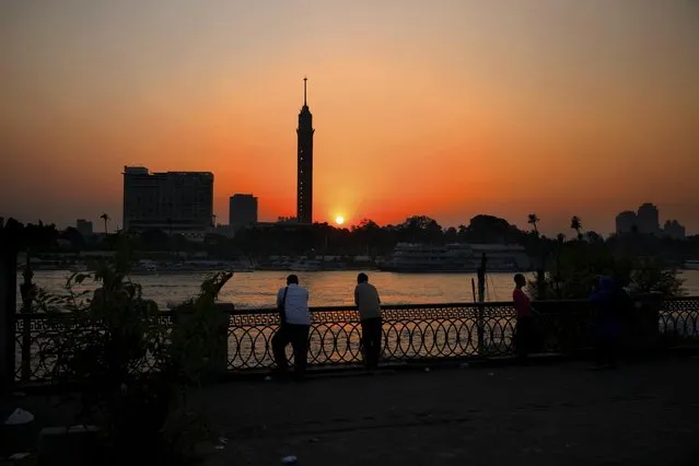 Egyptian men enjoy the sun setting over the Nile River in Cairo, Egypt, Wednesday, August 5, 2015. (Photo by Hassan Ammar/AP Photo)