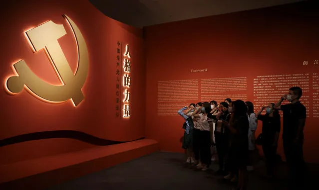 Visitors recite the party oath at an exhibition on the Chinese Communist Party ahead of its 101st founding anniversary, at the National Museum in Beijing, China on June 30, 2022. (Photo by Tingshu Wang/Reuters)