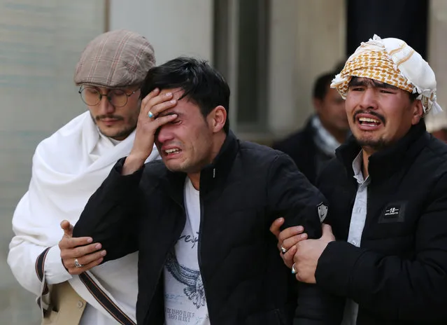 Afghan men cry at a hospital after they heard that their relative was killed during an attack in Kabul, Afghanistan on March 6, 2020. (Photo by Omar Sobhani/Reuters)