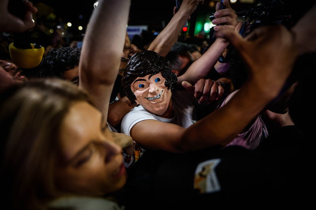 Supporters of the Argentine presidential candidate Javier Milei participate in a rally as they gather to await the results of the presidential elections, in Buenos Aires, Argentina, 22 October 2023. Some 35.4 million Argentines were summoned to, in addition to electing president and vice president, renew 130 of the 257 seats in the Chamber of Deputies and 24 of the 72 in the Senate, and appoint 43 Argentine representatives to the Mercosur Parliament (Parlasur, legislative body of the bloc made up of Argentina, Brazil, Paraguay and Uruguay). (Photo by Juan Ignacio Roncoroni/EPA)