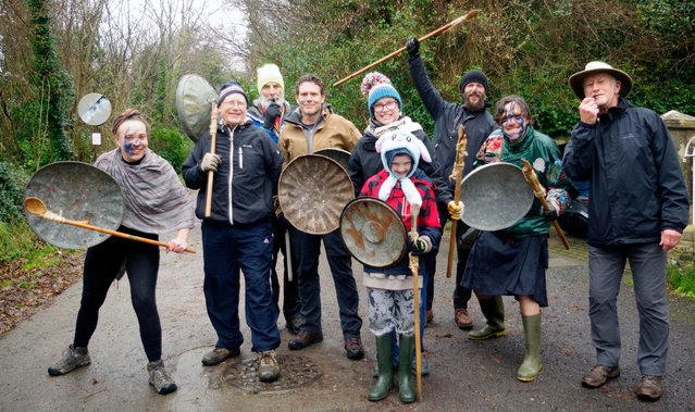A nurdling team prepare for action on the Old Roman Road in Upwey, near Weymouth in Dorset, UK on January 1, 2025. Players arm themselves with fenders (dustbin lids) and grouting poles and attempt to get their nurdle (a wooden block) up the road as the opposition tries to swipe it into the rough. The game is believed to date back to pre-Roman Britain. (Phoot by Idris Martin/BNPS)