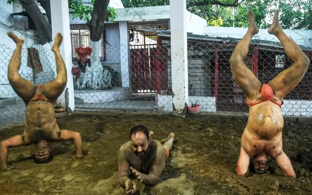 Amateur wrestlers practice at a traditional mud pit in Kolkata on May 9, 2020. (Photo by Dibyangshu Sarkar/AFP Photo)