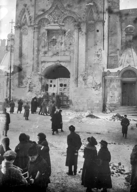 In this photo taken in October 1917, provided by Russian State Documentary Film and Photo Archive, people walk at the damaged Nikolskaya Tower right after the revolution fighting in Moscow, Russia. The 1917 Bolshevik Revolution was long before the digital revolution allowed anyone to instantly document events. But the clumsy cameras of the time still caught some images that capture the period's drama. (Photo by Russian State Documentary Film and Photo Archive via AP Photo)