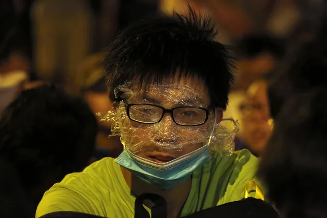 A protester wearing rudimentary protection against pepper spray is pictured during a confrontation with the police, after a rally for the October 1 “Occupy Central” civil disobedience movement in Hong Kong September 27, 2014. (Photo by Bobby Yip/Reuters)