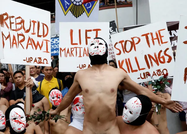 Naked mebers of the Alpha Phi Omega (APO) fraternity wearing masks attend a protest against extrajudicial killings and the lifting of martial law in the southern island of Mindanao, at the University of the Philippines in Quezon city, Metro Manila, Philippines December 1, 2017. (Photo by Dondi Tawatao/Reuters)