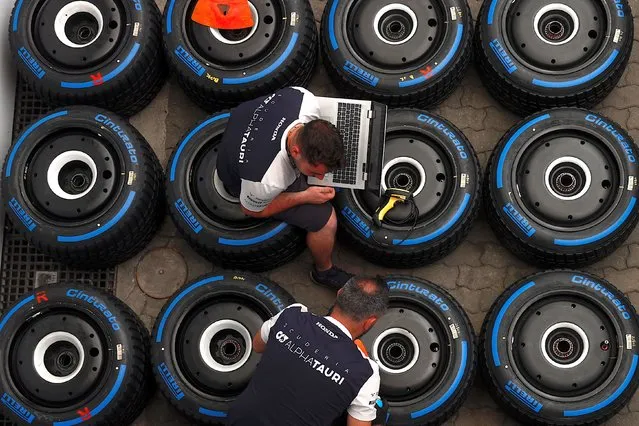Scuderia AlphaTauri team members sit on full wet tyres at the Autodromo Jose Carlos Pace circuit in Interlagos, Sao Paulo, Brazil, 10 November 2022. The Formula 1 Grand Prix of Sao Paulo will be held on 13 November 2022. (Photo by Fernando Bizerra/EPA/EFE)