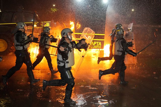 Police officers chase protesters during a rally against the passing of a controversial revision of a military law that will allow military officers to serve in more government posts without resigning from the armed forces, outside the parliament in Jakarta, Indonesia, Thursday, March 27, 2025. (Photo by Achmad Ibrahim/AP Photo)