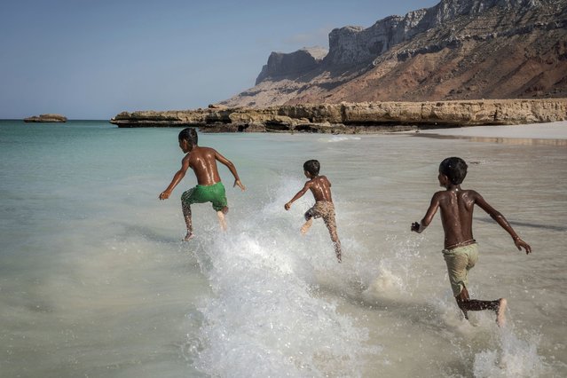 Children play in the waves on the Yemeni island of Socotra on September 22, 2024. (Photo by Annika Hammerschlag/AP Photo)