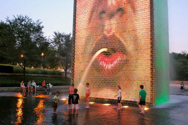 “Recycling”. A stream of water coming out of the mouth of one of the two video faces, splashing into the shallow pool. Crown Fountain, Millennium Park, Chicago, IL. (Photo by M.V. Jantzen)