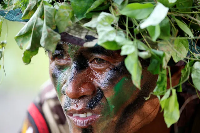 A camouflaged soldier waits for the arrival of Philippine President Rodrigo Duterte at the military's Scout Ranger Camp Tecson in San Miguel, Bulacan in northern Philippines September 15, 2016. (Photo by Erik De Castro/Reuters)