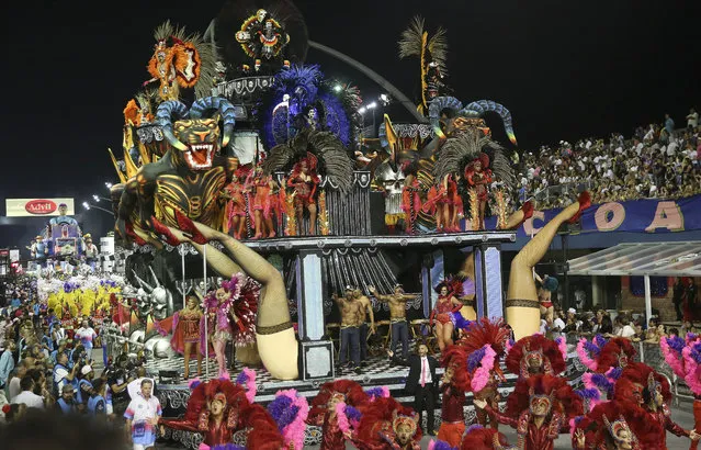 Dancers from the Rosas de Ouro samba school perform on a float during a carnival parade in Sao Paulo, Brazil, Saturday, February 10, 2018. (Photo by Andre Penner/AP Photo)