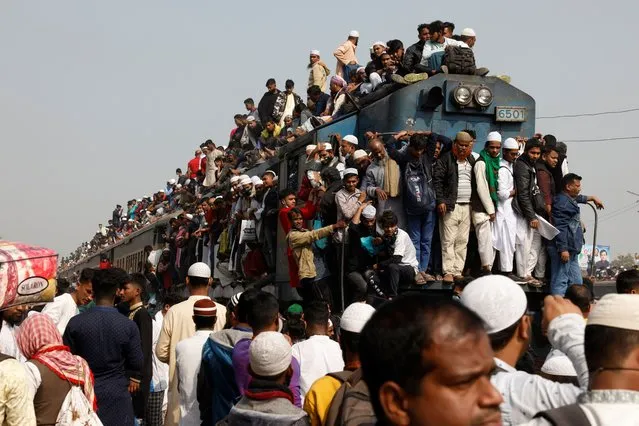 Devotees climb on the rooftop of an overcrowded train to return home, after attending the final prayer of Bishwa Ijtema, which is considered the world's second-largest Muslim gathering after Haj, in Tongi, outskirts of Dhaka, Bangladesh on January 15, 2023. (Photo by Mohammad Ponir Hossain/Reuters)