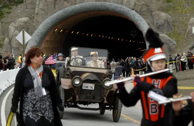 A marching band leads a vintage automobile through one of two tunnels that will replace a notorious stretch of California's Highway 1 at Devil's Slide near Pacifica, California March 25, 2013. The tunnels mark the completion of the $439 million transportation project, which bypass a steep, winding portion of the coastal highway south of San Francisco that has long been susceptible to rockslide-related closures. (Photo by Robert Galbraith/Reuters)