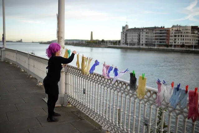 A protester hangs gloves with messages while taking part in a strike for women's rights in Portugalete, Spain, March 8, 2018, on International Women's Day. (Photo by Vincent West/Reuters)