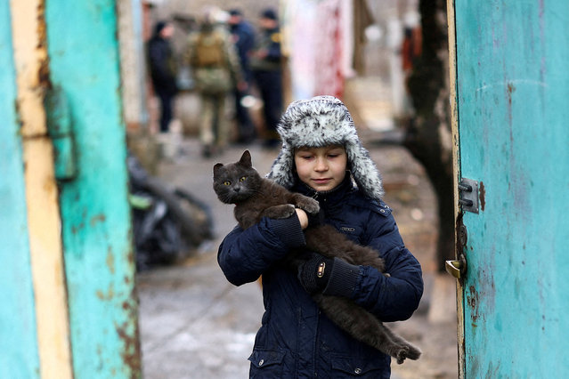 A boy carries his cat, while being evacuated, as Russia’s invasion of Ukraine continues, in Siversk, Donetsk region on February 28, 2023. (Photo by Lisi Niesner/Reuters)
