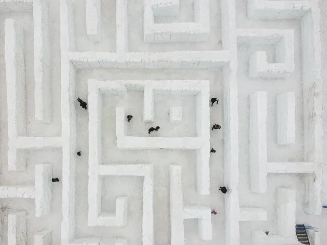A drone view of visitors trying to find their way through the biggest snow maze of the world in Zakopane, Poland, January 11, 2018. The snow maze idea was created for the first time in the winter season of 2015/2016. Maze covers an area of 2500 square meters and it is considered as the biggest snow maze in the world. This season, the organization increased the size to 3000 square meters keeping its title for the biggest snow maze in the world. (Photo by Omar Marques/Anadolu Agency/Getty Images)