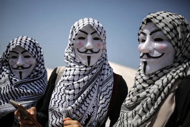 A group of Palestinian women protester with Guy Fawkes maskes and Palestinian keffiyehs attend a demonstration within the 'Great March of Return' at Israeli border in eastern part of Gaza City, Gaza on April 05, 2018. Dubbed the Great Return March, Fridays rallies in the Gaza Strip also coincide with Land Day, which commemorates the murder of six Palestinians by Israeli forces in 1976. It is also intended to pressure Israel to lift its decade-long blockade of the coastal enclave. (Photo by Ali Jadallah/Anadolu Agency/Getty Images)