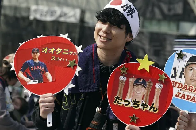 A fan of Japan's Shohei Ohtani and Lars Nootbaar cheer prior to the Pool B game between Japan and China at the World Baseball Classic (WBC) at the Tokyo Dome Thursday, March 9, 2023, in Tokyo. The paper fans read in Japanese “Mr. Ohtani Great !!” and “Tacchan (Japanese nickname for Nootbaar)”. Japanese baseball player Shohei Ohtani is arguably the game's best player. But he's more than just a baseball player. He's an antidote for many in his native country. (Photo by Eugene Hoshiko/AP Photo)