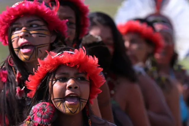 Brazilian Pataxo women take part in a ritual dance during a protest against a proposed constitutional amendment that would put the demarcation of indigenous lands into the hands of the Congress, in front of the Brazil's National Congress, in Brasilia, Brazil, Tuesday, November 10, 2015. A lower house commission has approved the proposal but it must make its way through the Senate, and be signed by President Dilma Rousseff to become law. (Photo by Eraldo Peres/AP Photo)