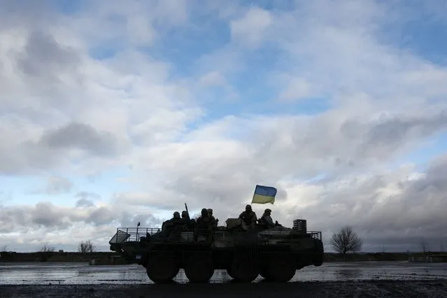 Ukrainian servicemen sit atop an armored personnel carrier (APC) at a military base in the town of Kramatorsk, eastern Ukraine, December 24, 2014. (Photo by Valentyn Ogirenko/Reuters)