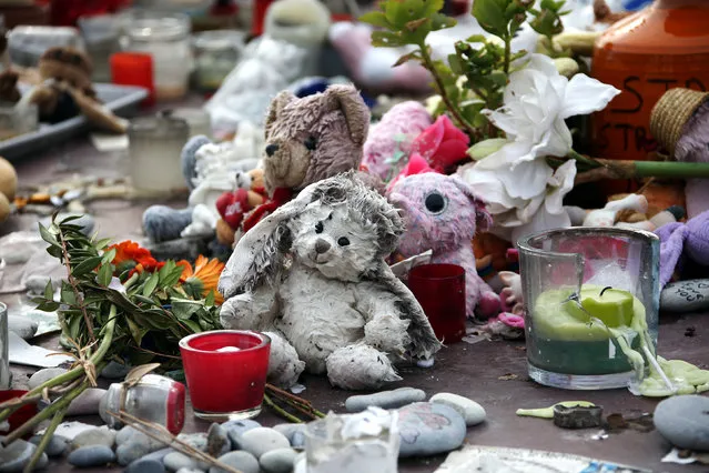 Toys are seen at a memorial for the victims of the fatal truck attack three months ago on the Promenade des Anglais, in NIce, France, October 16, 2016. (Photo by Eric Gaillard/Reuters)